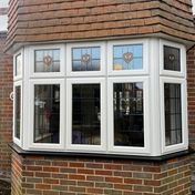 3-sided Kömmerling uPVC bay window with feature leads and stains.