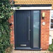 Composite door in anthracite, brushed steel bar handle and furniture. 