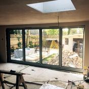During: Extension with black 4-panel bifold door and roof lantern